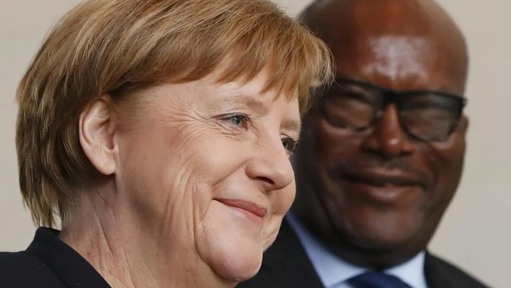 الرئيس البوركيني روك مارك اكريستيان كابوري، والمستشارة الألمانية أ?